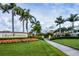 Community entrance to Gran Paradiso with lush landscaping and palm trees at 20169 Cristoforo Pl, Venice, FL 34293