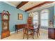 Bright dining room featuring a wooden table set, chandelier, and a grandfather clock at 20169 Cristoforo Pl, Venice, FL 34293