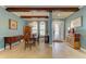 Elegant dining room with wood beams, chandelier and ample seating for dinner parties at 20169 Cristoforo Pl, Venice, FL 34293
