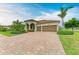 Stunning home with a tile roof, arched entryway and brick paver driveway at 20169 Cristoforo Pl, Venice, FL 34293