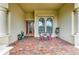 Charming front porch featuring brick pavers and seating area at 20169 Cristoforo Pl, Venice, FL 34293