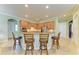 Kitchen with wood cabinetry, stainless appliances, granite counters, and breakfast bar seating at 20169 Cristoforo Pl, Venice, FL 34293