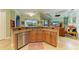 Kitchen features a breakfast bar, stainless steel appliances, and granite countertops at 20169 Cristoforo Pl, Venice, FL 34293