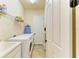 Laundry room with washer, dryer, sink, and storage shelves at 20169 Cristoforo Pl, Venice, FL 34293