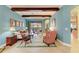 Cozy living room featuring wood beams, tile floors, and plenty of natural light at 20169 Cristoforo Pl, Venice, FL 34293