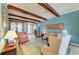 Spacious living room featuring wooden beams, tile floors, and an open layout at 20169 Cristoforo Pl, Venice, FL 34293