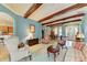 Inviting living room showcasing wood beams, tile flooring, and an open floor plan at 20169 Cristoforo Pl, Venice, FL 34293