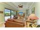 Spacious living room with coffered ceiling, leather furniture, and view of the pool at 20169 Cristoforo Pl, Venice, FL 34293