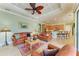 Living room with leather seating, coffered ceiling, and open to the kitchen and dining area at 20169 Cristoforo Pl, Venice, FL 34293