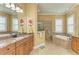 Relax in this spa-like main bathroom with dual vanities, granite countertops, a soaking tub, and a separate shower at 20169 Cristoforo Pl, Venice, FL 34293