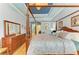Elegant main bedroom featuring a four-poster bed, wood floors, and dresser at 20169 Cristoforo Pl, Venice, FL 34293