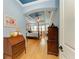Elegant main bedroom features a four-poster bed, wood floors, and tray ceiling at 20169 Cristoforo Pl, Venice, FL 34293