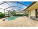 An inviting screened-in pool, brick patio, and lush landscaping offer an ideal outdoor living space at 20169 Cristoforo Pl, Venice, FL 34293