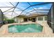 A beautiful backyard screened-in pool with brick patio is perfect for entertaining at 20169 Cristoforo Pl, Venice, FL 34293