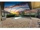 Screened in pool area with brick patio and beautiful sunset view at 20169 Cristoforo Pl, Venice, FL 34293