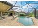Beautiful pool with a screened enclosure and brick patio for relaxing or entertaining guests at 20169 Cristoforo Pl, Venice, FL 34293