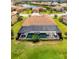 An aerial view of a home with a screened-in pool and tile roof at 20443 Cristoforo Pl, Venice, FL 34293
