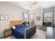 Bright bedroom with hardwood floors, ceiling fan, and a full-size bed at 20443 Cristoforo Pl, Venice, FL 34293