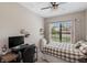 Comfortable bedroom with a desk, a large window, and a cozy bed at 20443 Cristoforo Pl, Venice, FL 34293