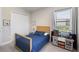 bedroom featuring a play kitchen and comfortable bed near a sunny window at 20443 Cristoforo Pl, Venice, FL 34293