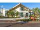 Bright community clubhouse with modern architecture, lush landscaping, and outdoor seating at 20443 Cristoforo Pl, Venice, FL 34293