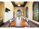 A long table and several chairs make up a conference room, also featuring natural light at 20443 Cristoforo Pl, Venice, FL 34293