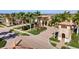 Community entrance features a charming guard house, mature landscaping, and decorative brick pavers at 20443 Cristoforo Pl, Venice, FL 34293
