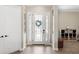 Bright foyer showcasing a decorative front door with sidelights and tile flooring at 20443 Cristoforo Pl, Venice, FL 34293