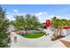 Inviting community gathering space with colorful seating, lush landscaping, and nearby lake at 20443 Cristoforo Pl, Venice, FL 34293