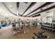 Spacious gym area with various exercise machines, high ceilings, and ceiling fans providing a great workout atmosphere at 20443 Cristoforo Pl, Venice, FL 34293