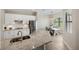 Modern kitchen with white cabinets, granite countertops, and stainless steel appliances at 20443 Cristoforo Pl, Venice, FL 34293