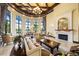 An elegant lobby features comfortable seating, fireplace, views of the pool and lush outdoor scenery at 20443 Cristoforo Pl, Venice, FL 34293