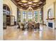 The lobby features abundant natural light, comfortable seating areas, elegant decor, and a cozy fireplace at 20443 Cristoforo Pl, Venice, FL 34293