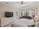 This bedroom features a large bay window, tray ceiling, and adjacent bathroom at 20443 Cristoforo Pl, Venice, FL 34293