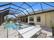 Spacious outdoor screened pool and patio with dining and lounge area at 20443 Cristoforo Pl, Venice, FL 34293