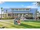 Community outdoor play area with playhouses, and ample green space at 20443 Cristoforo Pl, Venice, FL 34293