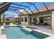 A luxurious screened pool with outdoor seating area at 20443 Cristoforo Pl, Venice, FL 34293