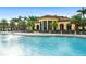 A resort-style community pool offers a relaxing experience with ample seating and palm trees at 20443 Cristoforo Pl, Venice, FL 34293