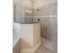 Modern bathroom shower featuring sleek glass enclosure and neutral tiled walls at 20443 Cristoforo Pl, Venice, FL 34293