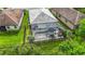 Aerial view of the home showcasing a screened-in pool and patio, beautiful landscaping, and a fenced yard at 20749 Swallowtail Ct, Venice, FL 34293