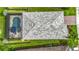 An aerial shot highlighting the home's roof and screened-in pool, set within lush green landscaping and a fenced yard at 20749 Swallowtail Ct, Venice, FL 34293