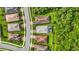 Aerial view of the house in a neighborhood, fenced in backyard with screened-in pool, and green spaces at 20749 Swallowtail Ct, Venice, FL 34293