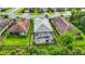Aerial view of the fenced-in backyard features a screened-in pool and spa plus an outdoor seating area at 20749 Swallowtail Ct, Venice, FL 34293
