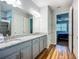 Bright bathroom featuring dual sinks, granite countertops, and entry to the main bedroom at 20749 Swallowtail Ct, Venice, FL 34293