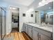 Bathroom featuring dual sinks, granite countertops, walk-in shower, and walk-in closet at 20749 Swallowtail Ct, Venice, FL 34293