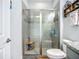 Modern bathroom featuring a glass enclosed shower with gray tile surround and built in seat at 20749 Swallowtail Ct, Venice, FL 34293