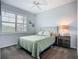 Bright bedroom featuring a neutral color scheme, large window, and ceiling fan at 20749 Swallowtail Ct, Venice, FL 34293