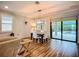 Dining area with view of the pool, hardwood floors, and modern chandelier fixture at 20749 Swallowtail Ct, Venice, FL 34293
