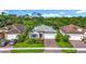 Exterior shot of a house featuring a two-car garage, neat landscaping, and a well-maintained facade at 20749 Swallowtail Ct, Venice, FL 34293