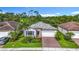 Beautiful front of home featuring a two-car garage, neat landscaping, and a well-maintained facade at 20749 Swallowtail Ct, Venice, FL 34293